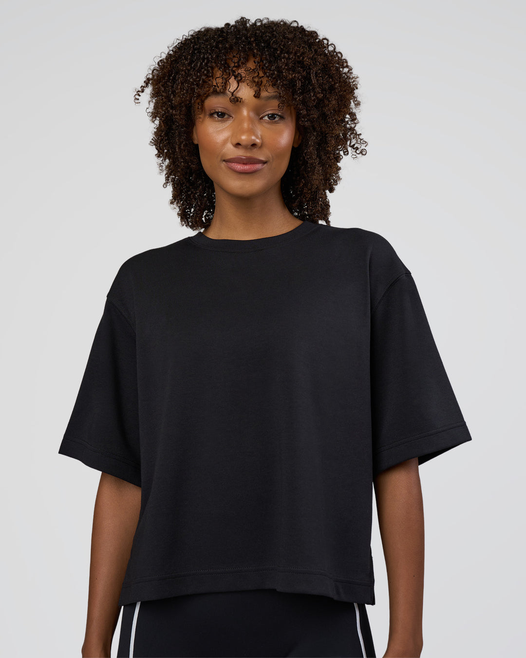 Woman wearing AfterDark ZeroCrease Cropped Tee - Black | Model:Tomi | Size:S