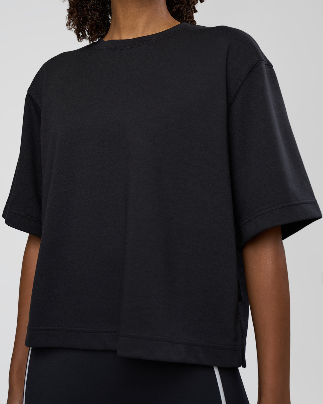 Woman wearing AfterDark ZeroCrease Cropped Tee - Black | Model:Tomi | Size:S