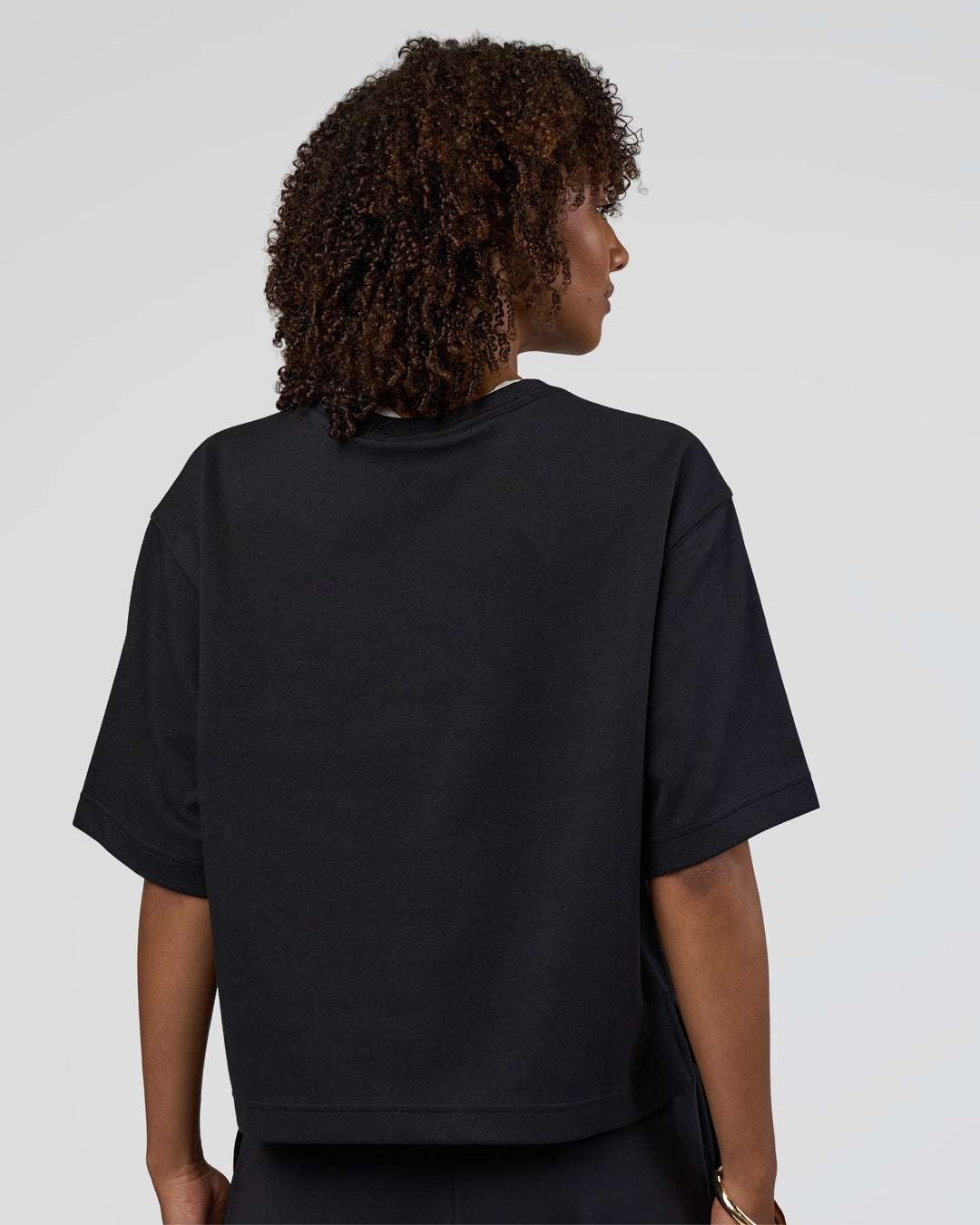 Woman wearing AfterDark ZeroCrease Cropped Tee - Black | Model:Tomi | Size:S