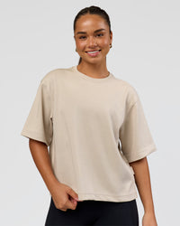 Woman wearing AfterDark ZeroCrease Cropped Tee - Shale Beige | Model:Sophia | Size:S