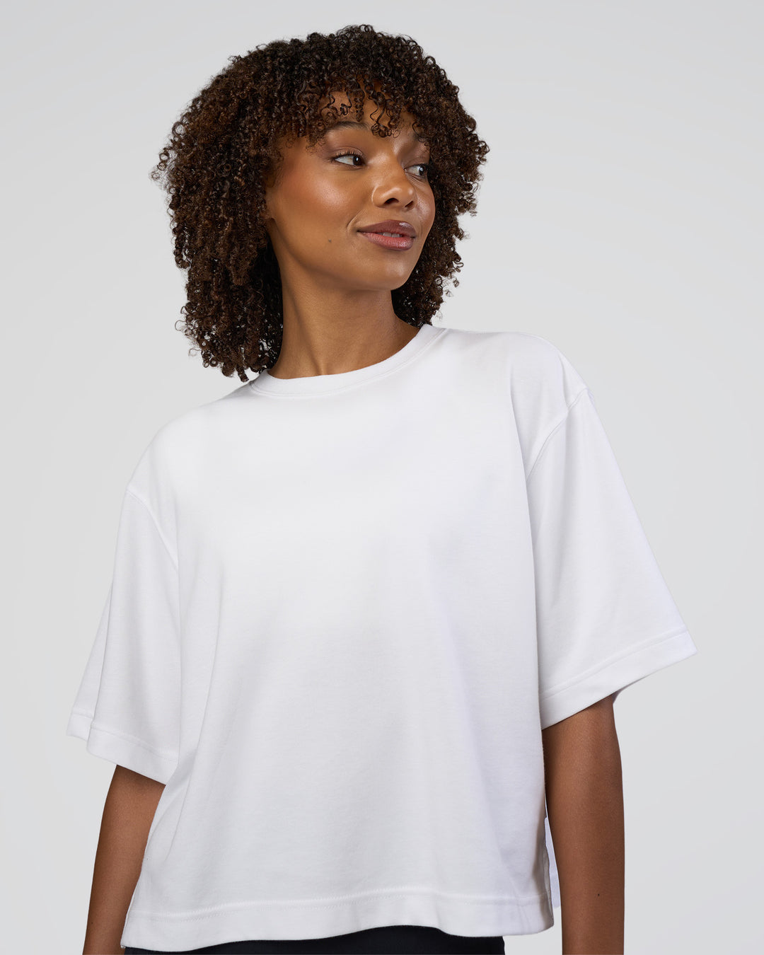Woman wearing AfterDark ZeroCrease Cropped Tee - White | Model:Tomi | Size:S