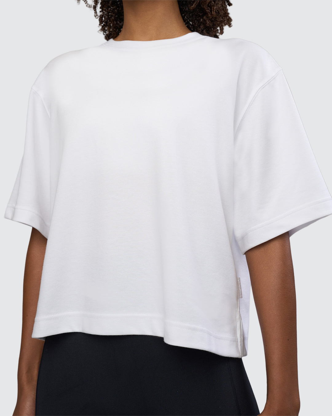 Woman wearing AfterDark ZeroCrease Cropped Tee - White | Model:Tomi | Size:S