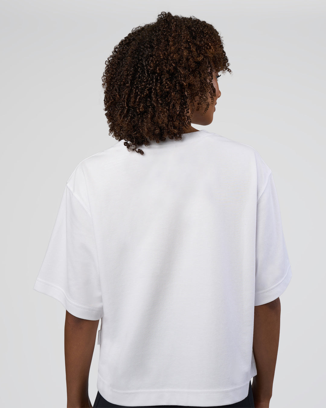 Woman wearing AfterDark ZeroCrease Cropped Tee - White | Model:Tomi | Size:S