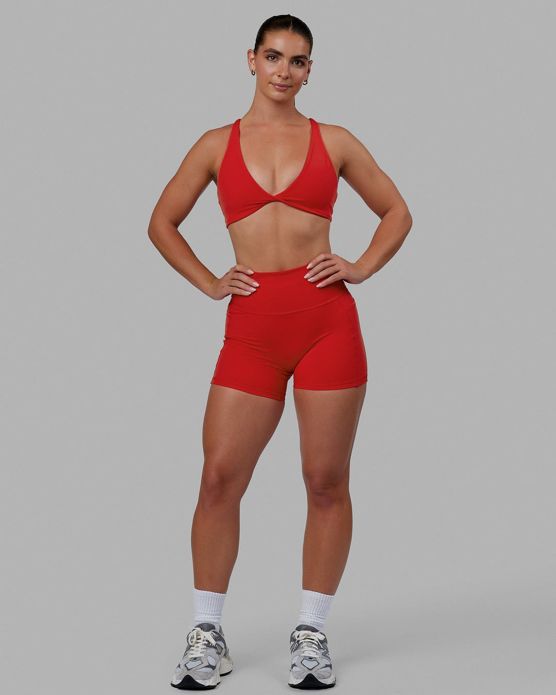 Woman wearing Agile Sports Bra - Infrared