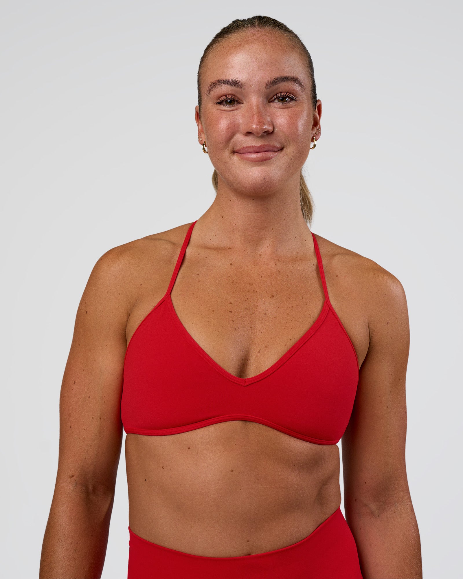 Woman wearing Ambience Sports Bra - Flame | Model:Sav | Size:S