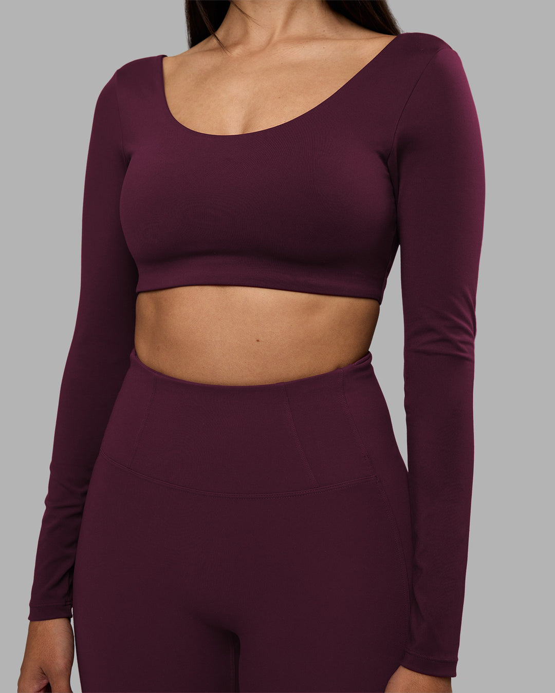Woman wearing Aria Long Sleeve Sports Bra - Cherry Lacquer | Model:Rhiley | Size:S