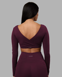 Woman wearing Aria Long Sleeve Sports Bra - Cherry Lacquer | Model:Rhiley | Size:S