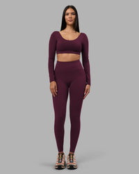 Woman wearing Aria Long Sleeve Sports Bra - Cherry Lacquer | Model:Rhiley | Size:S