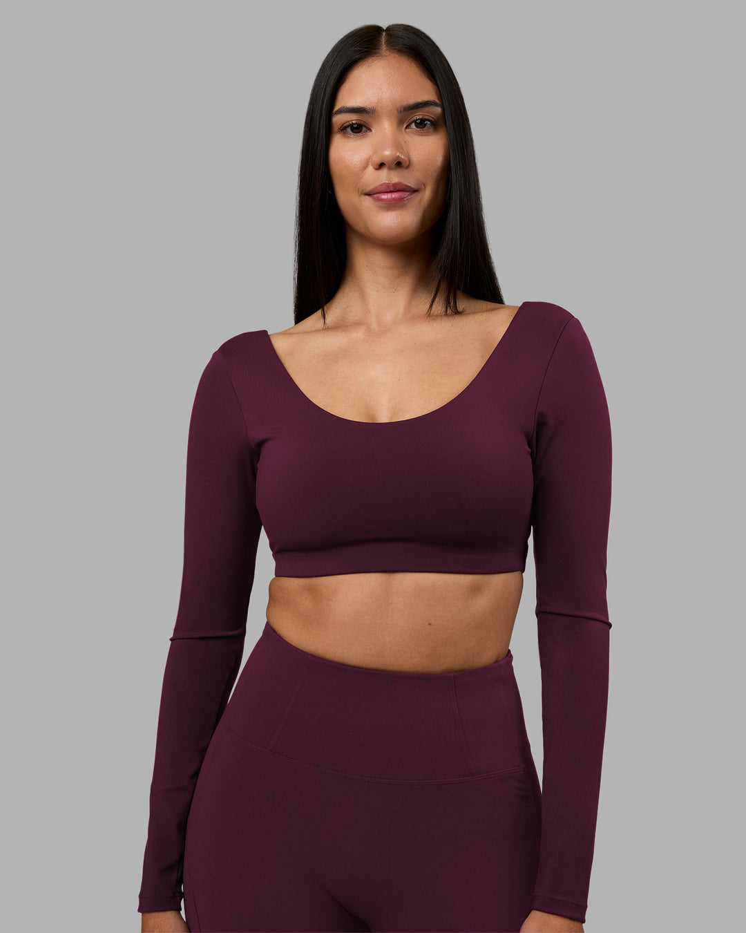Woman wearing Aria Long Sleeve Sports Bra - Cherry Lacquer | Model:Rhiley | Size:S