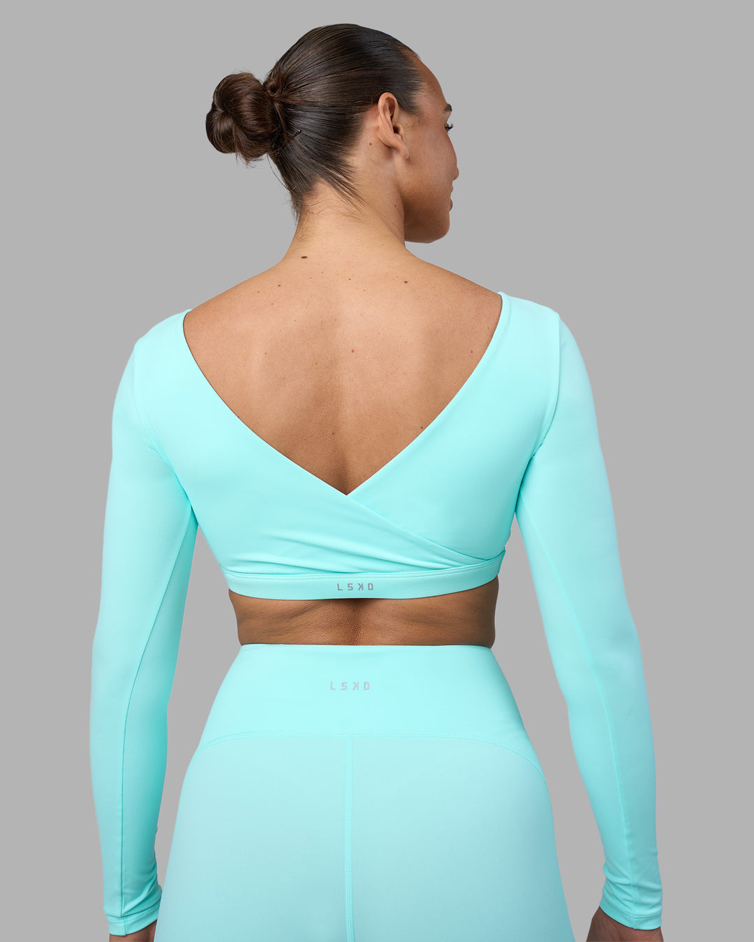 Woman wearing Aria Long Sleeve Sports Bra - Island Paradise | Model:Sophie | Size:S