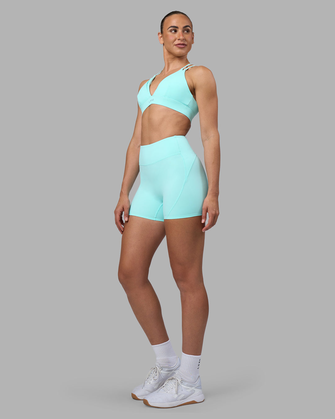Woman wearing Aria Triangle Sports Bra - Island Paradise | Model:Sophie | Size:S