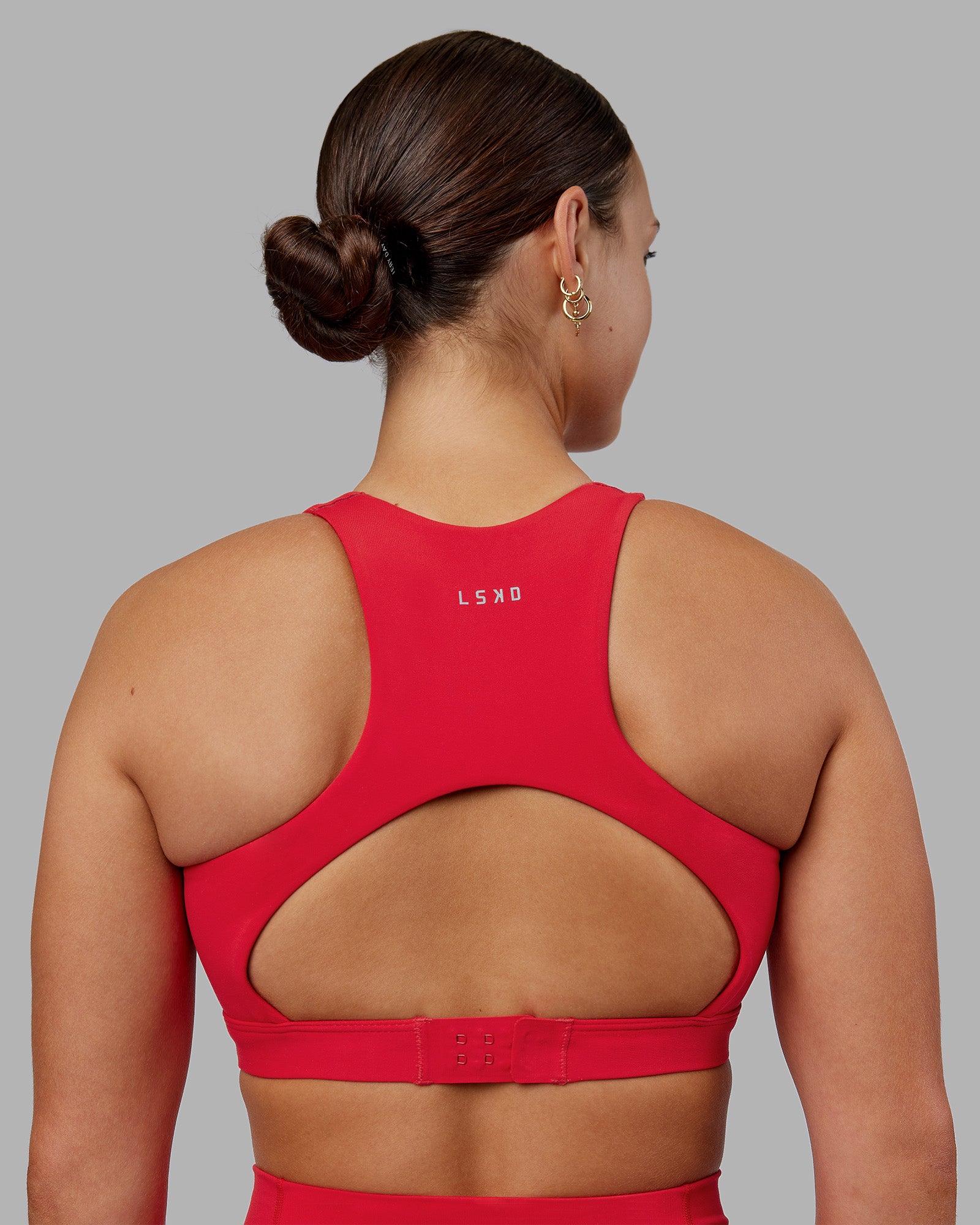 Woman wearing Ascent Sports Bra - Scarlet | Model:Keisha | Size:S