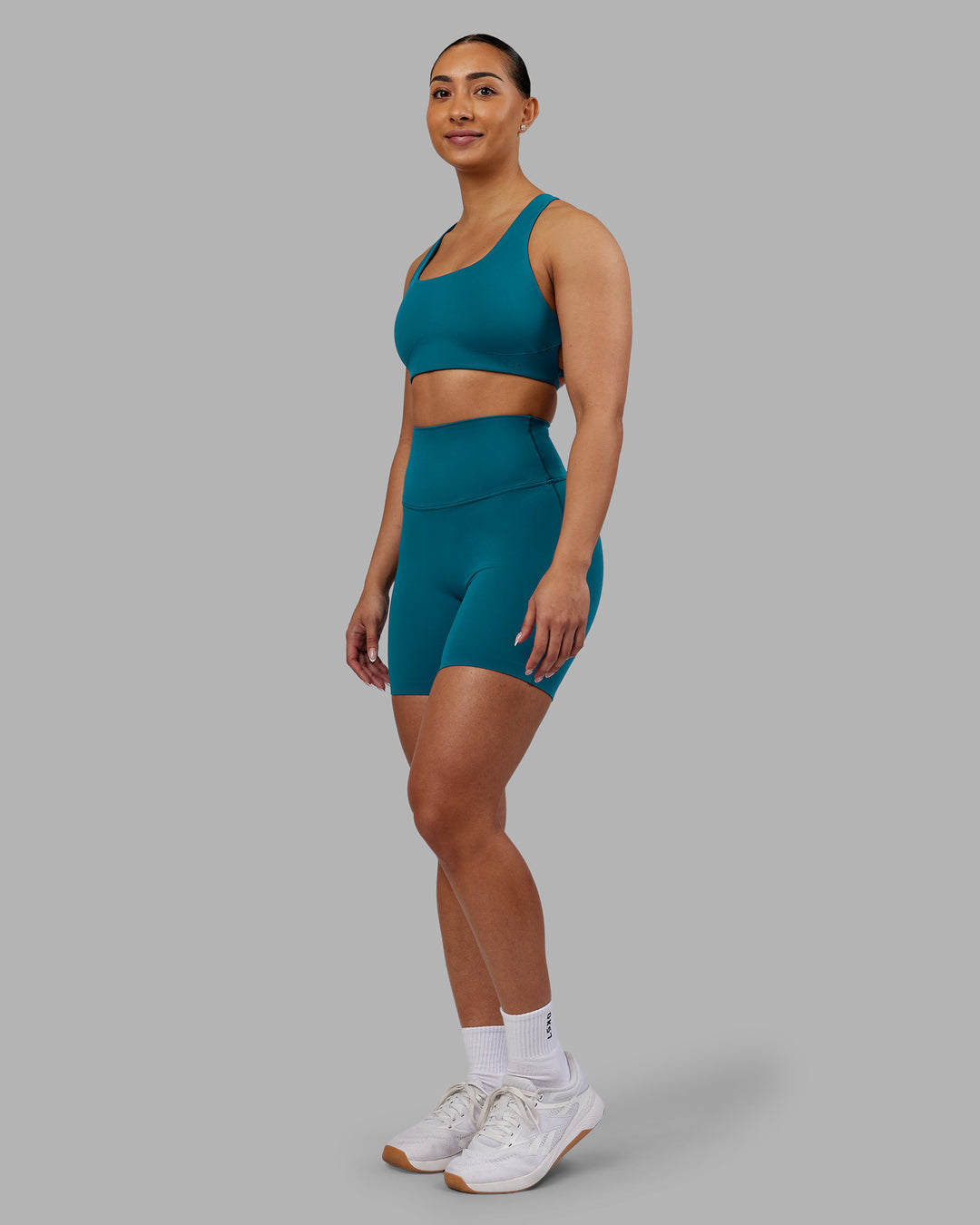 Woman wearing Aspire Sports Bra - Blue Coral | Model:Ayla | Size:S