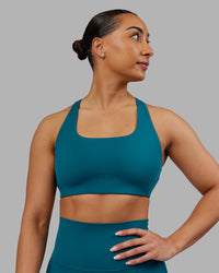 Woman wearing Aspire Sports Bra - Blue Coral | Model:Ayla | Size:S