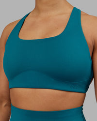 Woman wearing Aspire Sports Bra - Blue Coral | Model:Ayla | Size:S