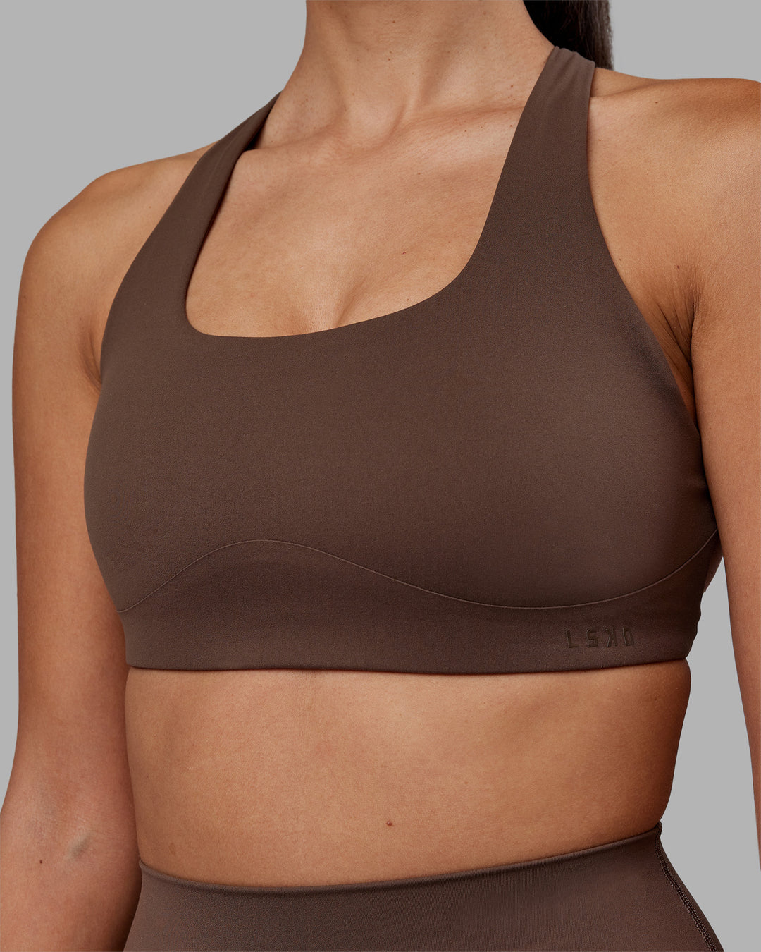Woman wearing Aspire Sports Bra - Chocolate Martini | Model:Rhiley | Size:S