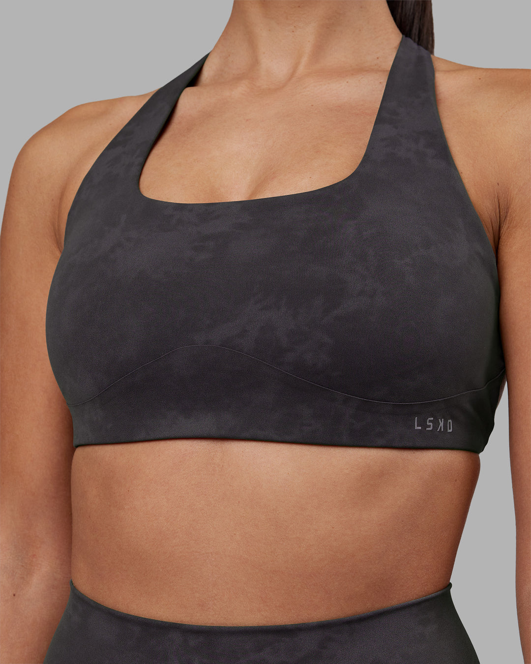Woman wearing Aspire Sports Bra - Dark Storm Wash | Model:Rhiley | Size:S
