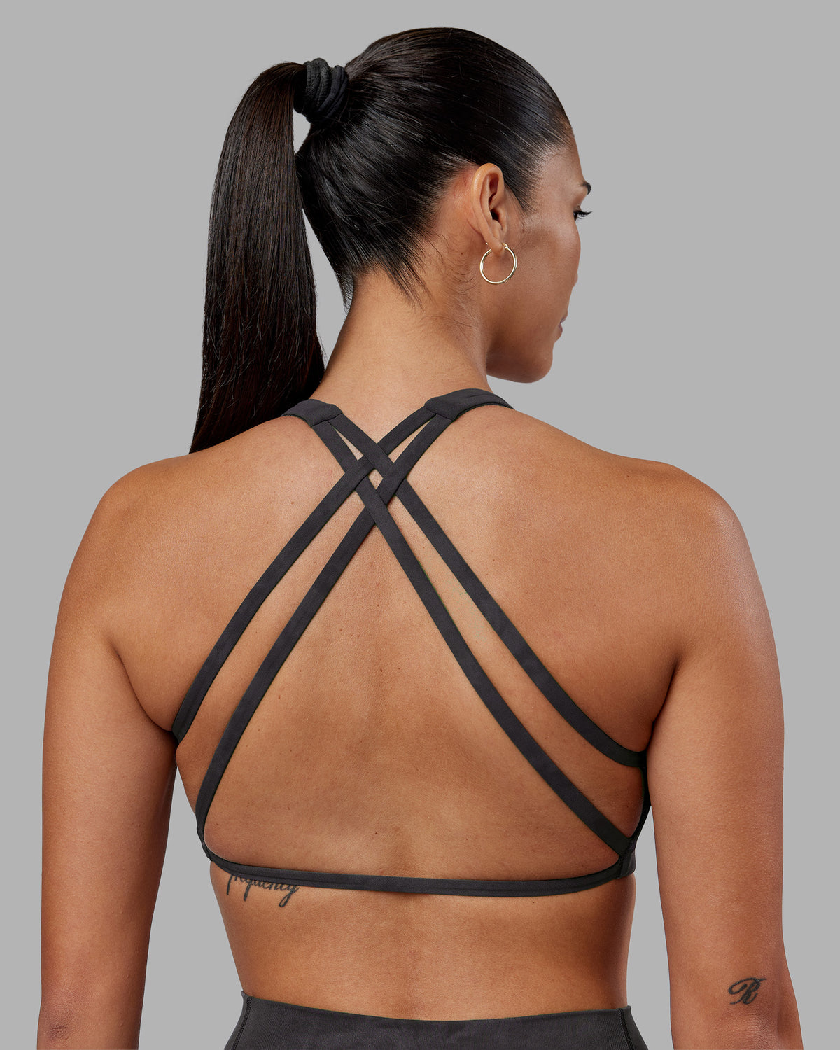 Woman wearing Aspire Sports Bra - Dark Storm Wash | Model:Rhiley | Size:S