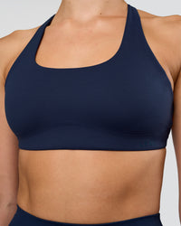 Woman wearing Aspire Sports Bra - Future Navy | Model:Evie | Size:S