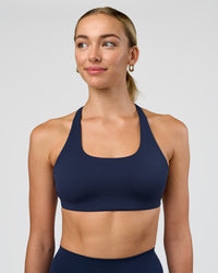 Woman wearing Aspire Sports Bra - Future Navy | Model:Evie | Size:S