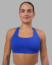 Woman wearing Aspire Sports Bra - Power Cobalt | Model:Keisha | Size:S