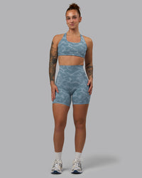 Woman wearing Aspire Sports Bra - Tranquil-Elemental Blue