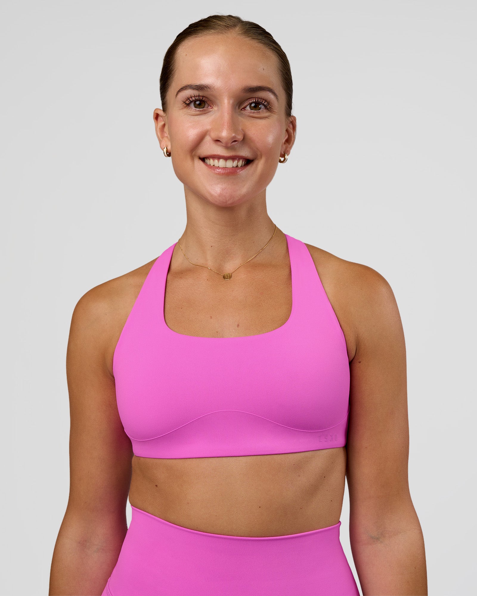Woman wearing Aspire Sports Bra - Ultra Fuchsia | Model:Myrte | SIze:S