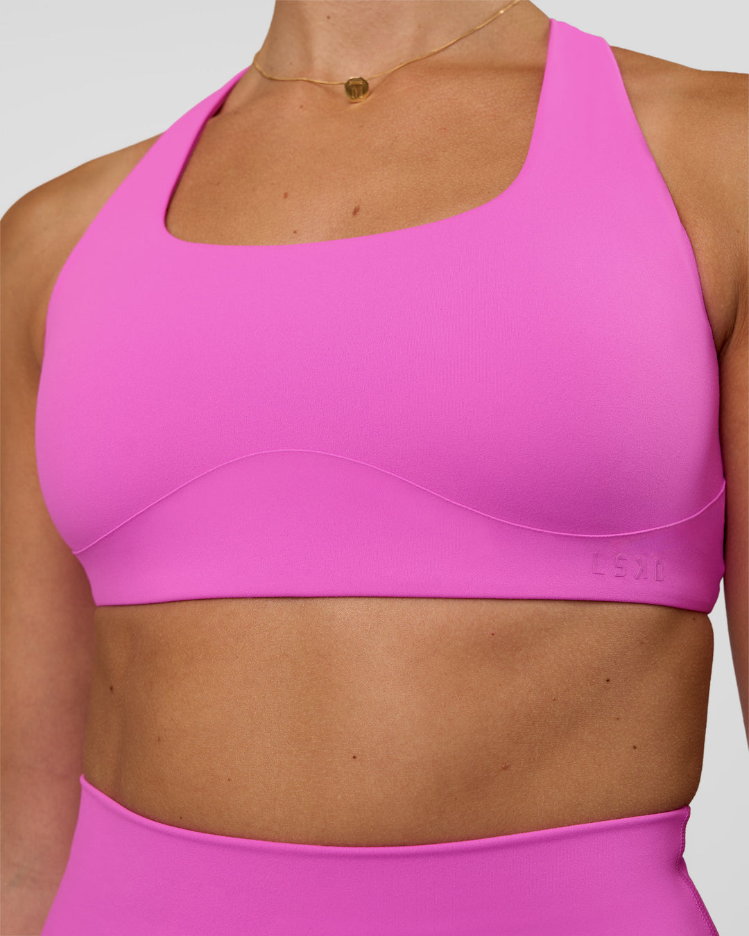 Woman wearing Aspire Sports Bra - Ultra Fuchsia | Model:Myrte | SIze:S