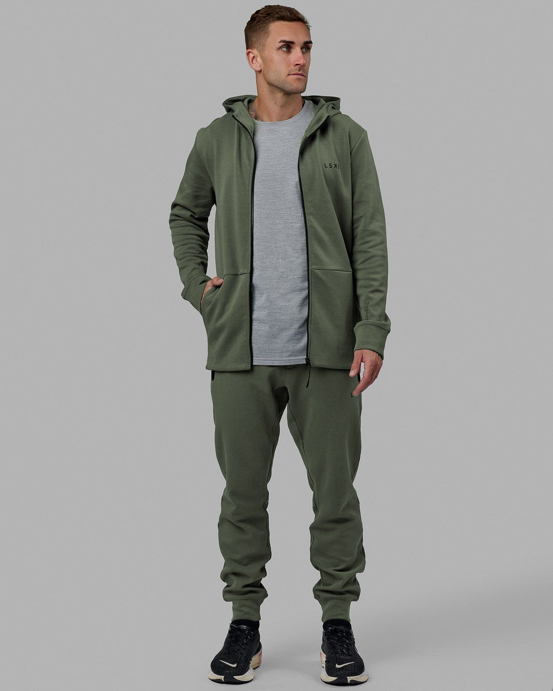 Man wearing Athlete ForgedFleece Zip Track Pants - Dark Forest