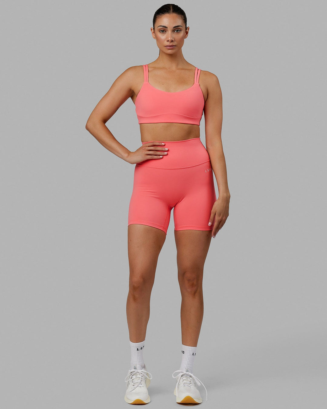 Woman wearing Base 2.0 Mid Short Tights - Coral