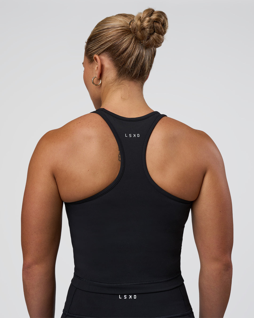 Woman wearing Be Bold Performance Tank - Black | Model:Tenaya | Size:S