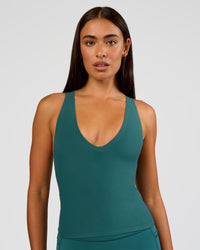 Woman wearing Bend & FLX Plunge Tank - Transformative Teal | Model:Ruby | Size:S