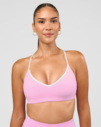 Woman wearing Blushing Sports Bra - Pink Rose-White | Model:Rhiley | Size:S