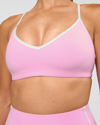 Woman wearing Blushing Sports Bra - Pink Rose-White | Model:Rhiley | Size:S