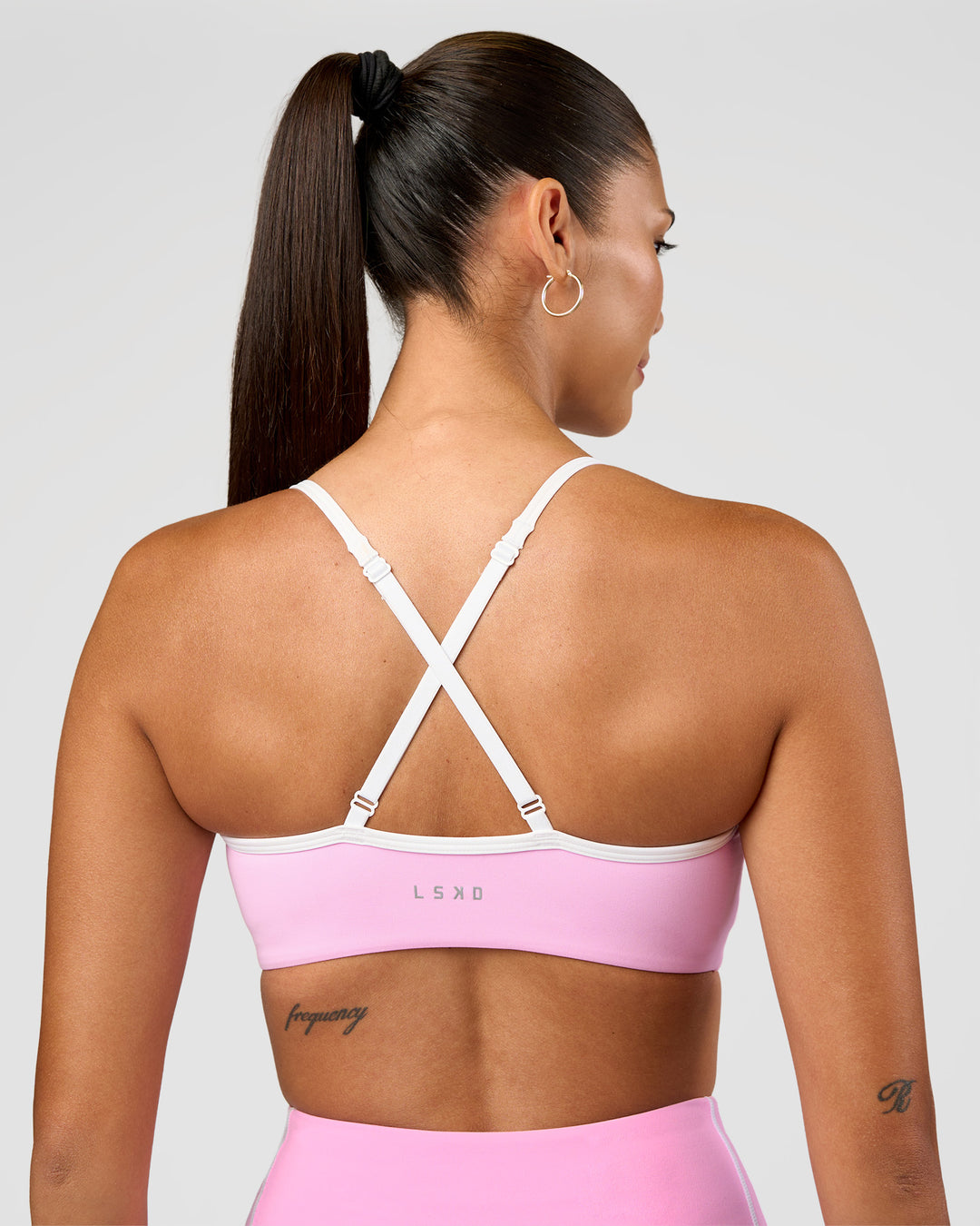 Woman wearing Blushing Sports Bra - Pink Rose-White | Model:Rhiley | Size:S