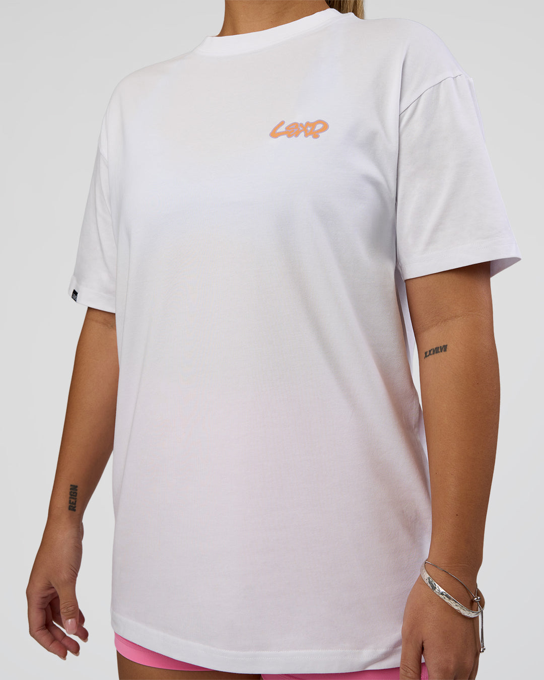 Woman wearing Break Through FLXCotton Oversized Tee - White-Pale Lilac | Model:Renee | Size:S