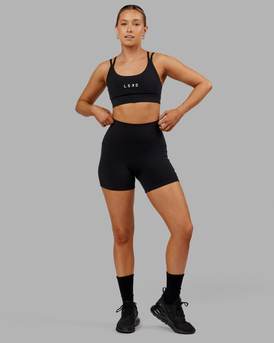 Woman wearing Bridge Sports Bra - Black-White