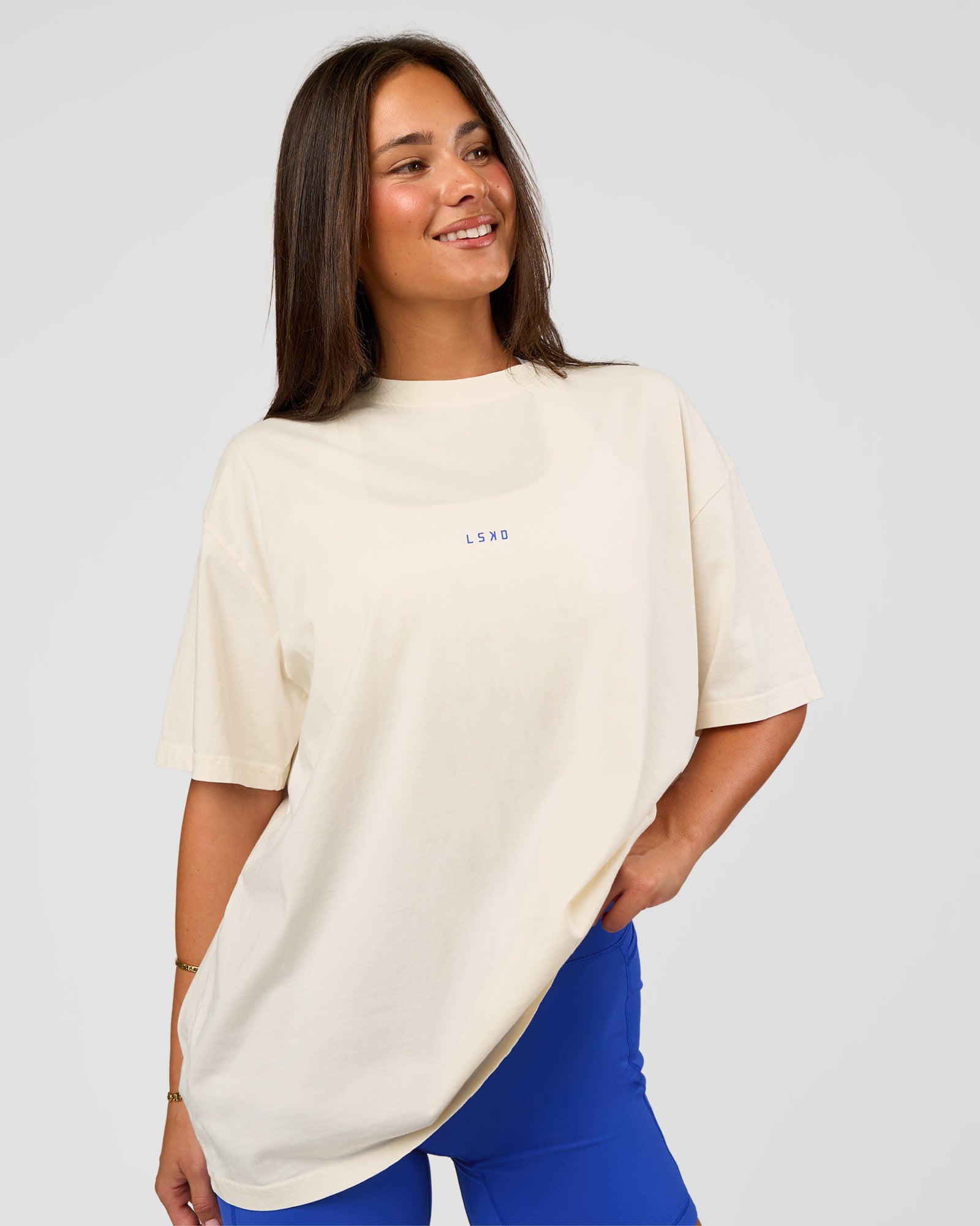 Woman wearing Built On Values Oversized Washed Tee - Off White Washed-Electric Indigo | Model:Bianca | Size:S