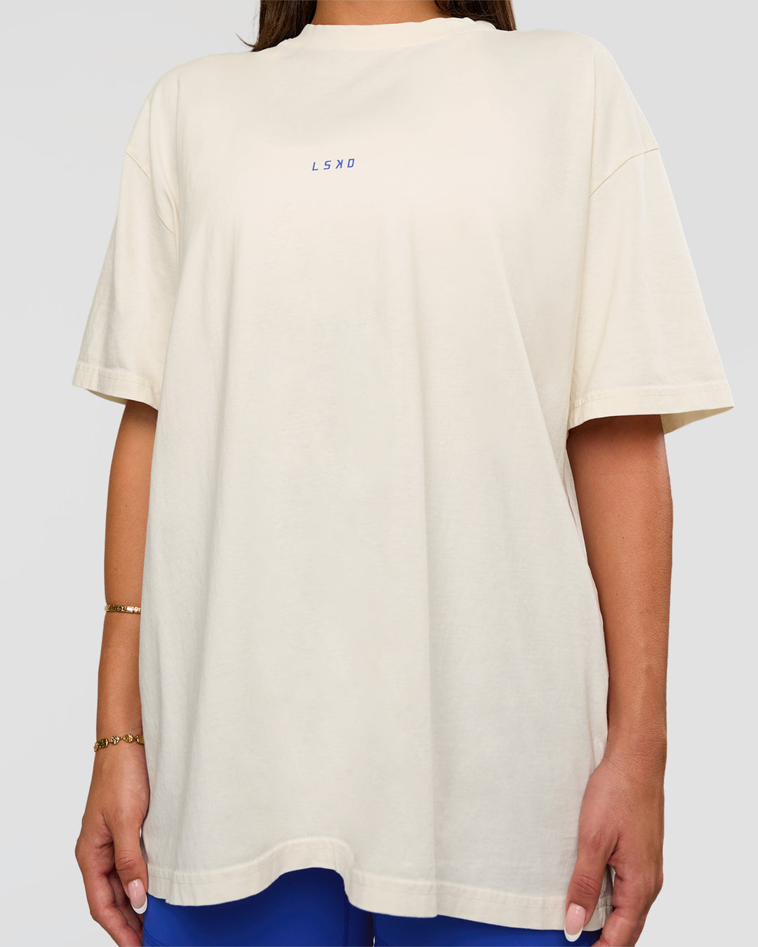 Woman wearing Built On Values Oversized Washed Tee - Off White Washed-Electric Indigo | Model:Bianca | Size:S