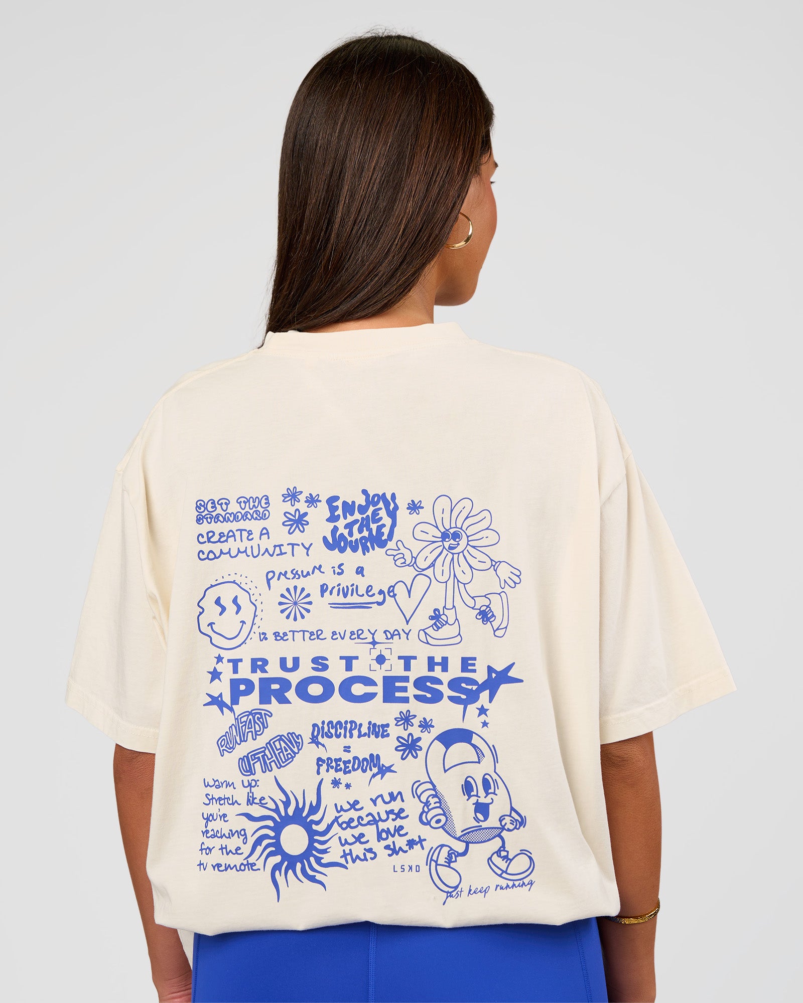 Woman wearing Built On Values Oversized Washed Tee - Off White Washed-Electric Indigo | Model:Bianca | Size:S