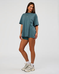Woman wearing Built On Values Oversized Washed Tee - Transformative Teal Washed-White | Model:Bianca | Size:S