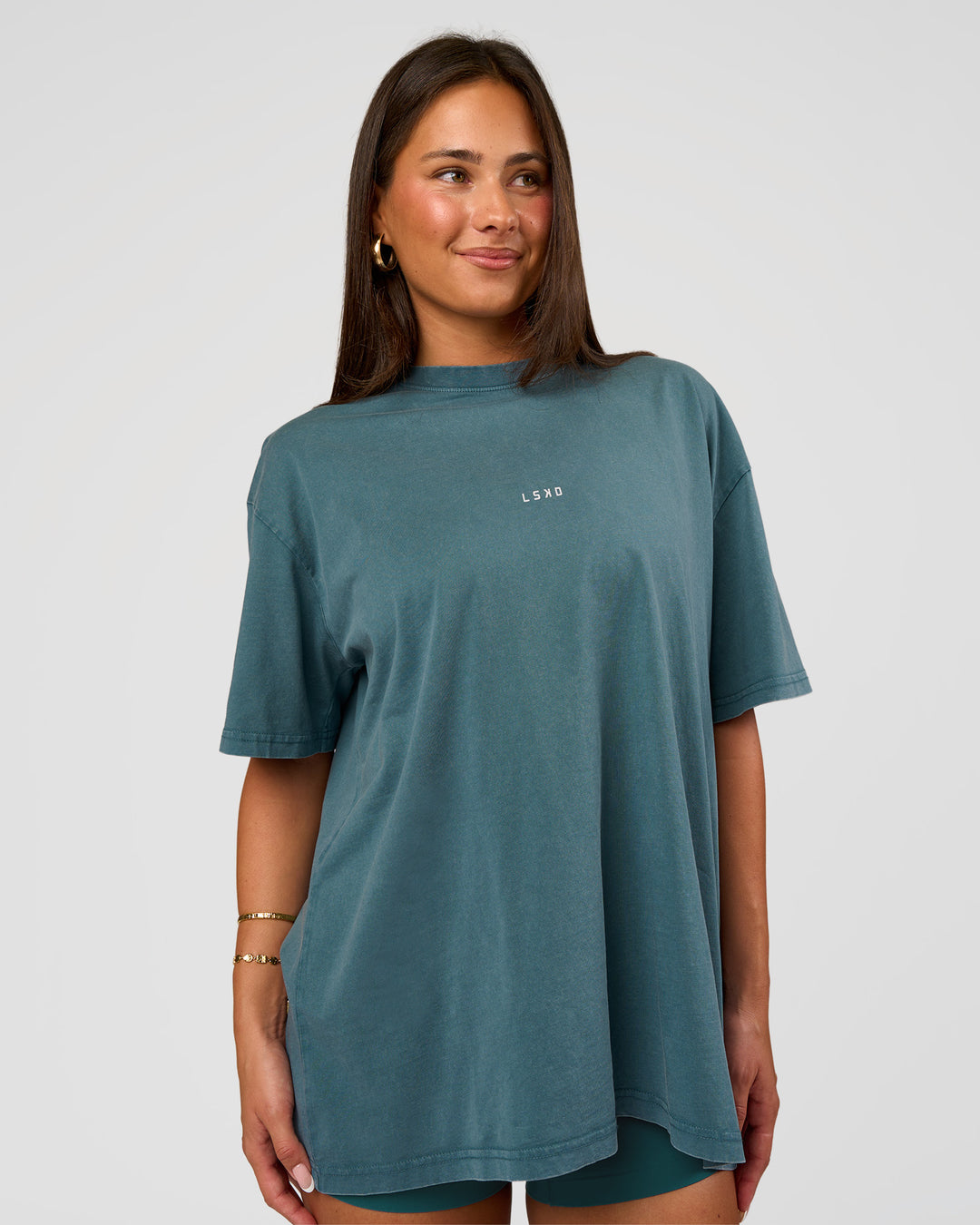 Woman wearing Built On Values Oversized Washed Tee - Transformative Teal Washed-White | Model:Bianca | Size:S