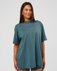 Woman wearing Built On Values Oversized Washed Tee - Transformative Teal Washed-White | Model:Bianca | Size:S