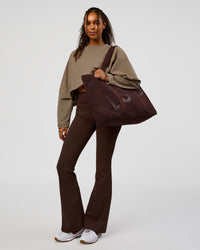Model wearing CF Fold Over High-Rise Flared Legging - Hot Chocolate | Model:Jordan | Size:S