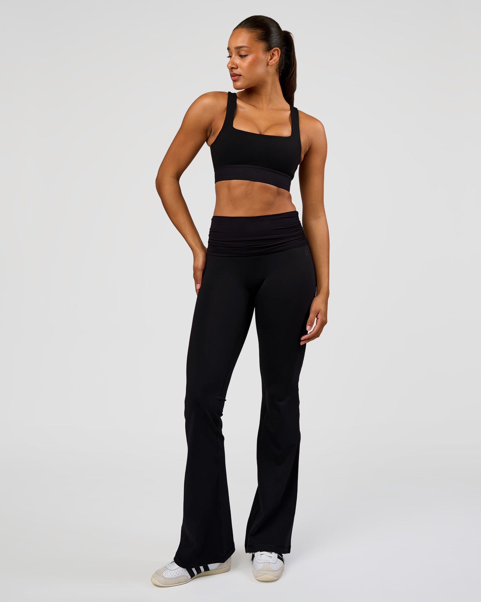Woman wearing CF Fold Over High-Rise Flared Legging Tall - Black | Model:Rosie | Size:S