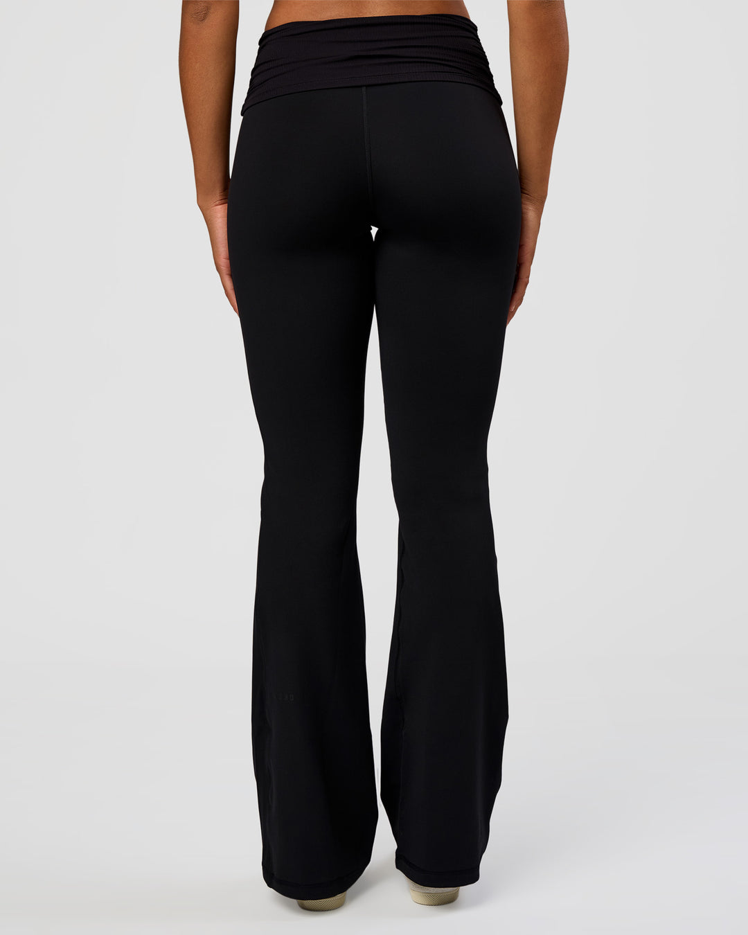 Woman wearing CF Fold Over High-Rise Flared Legging Tall - Black | Model:Rosie | Size:S