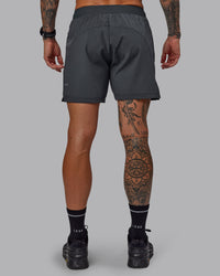 Man wearing Challenger 6" Performance Short in Dark Storm | Size:S