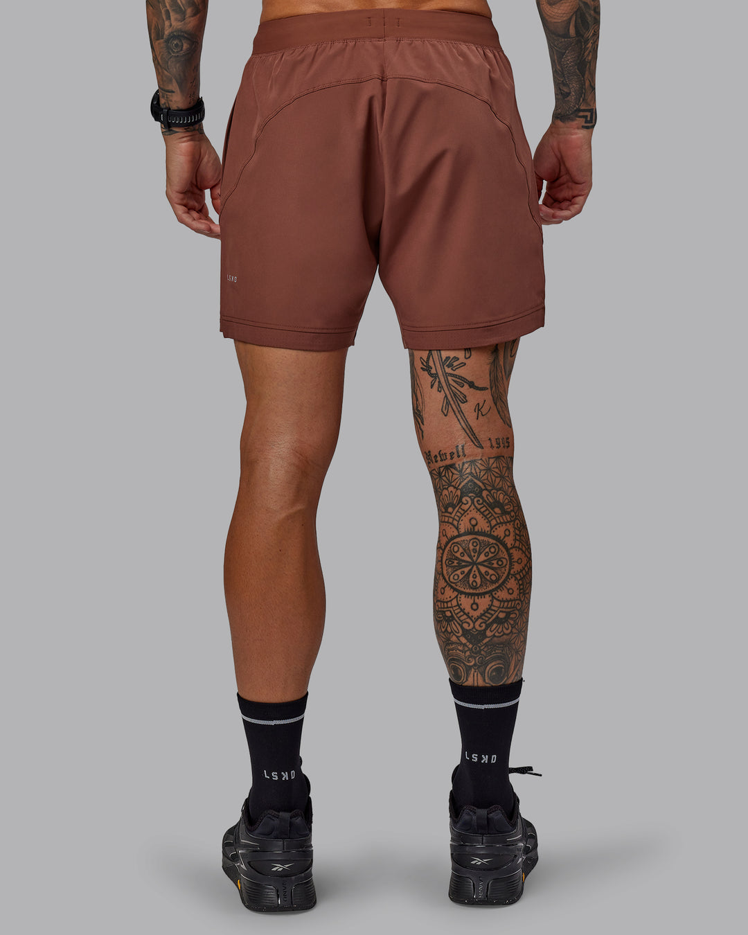 Man wearing Challenger 6&quot; Performance Short in Mahogany | Size:S