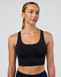 Woman wearing Circuit Longline Sports Bra - Black | Model:Evie | Size:S | Thumbnail Index: 0