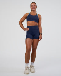 Woman wearing Distinction Sports Bra 2.0 - Future Navy-Baltic Sea | Model:Sav | Size:S